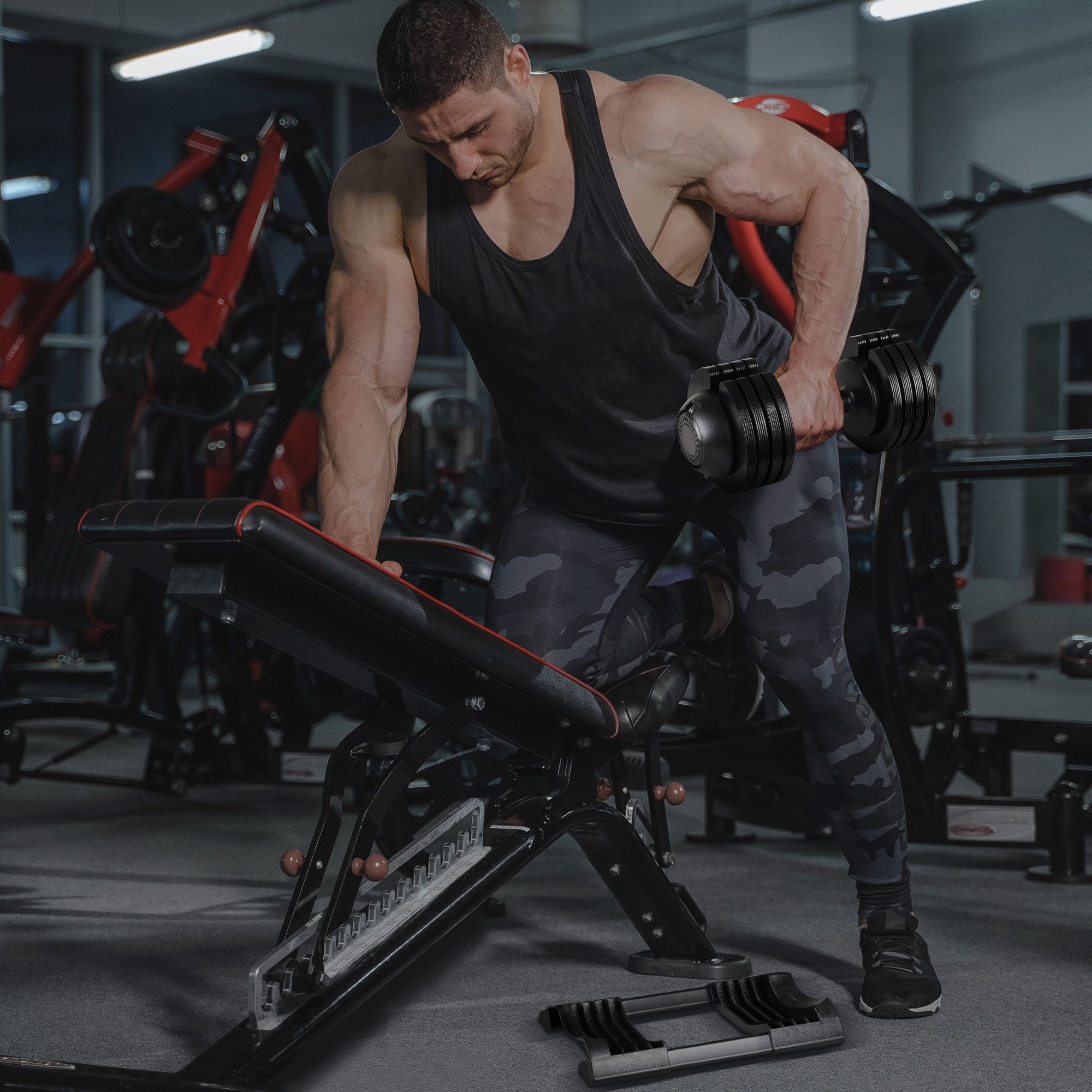 Man exercising with dumbbells in a gym.