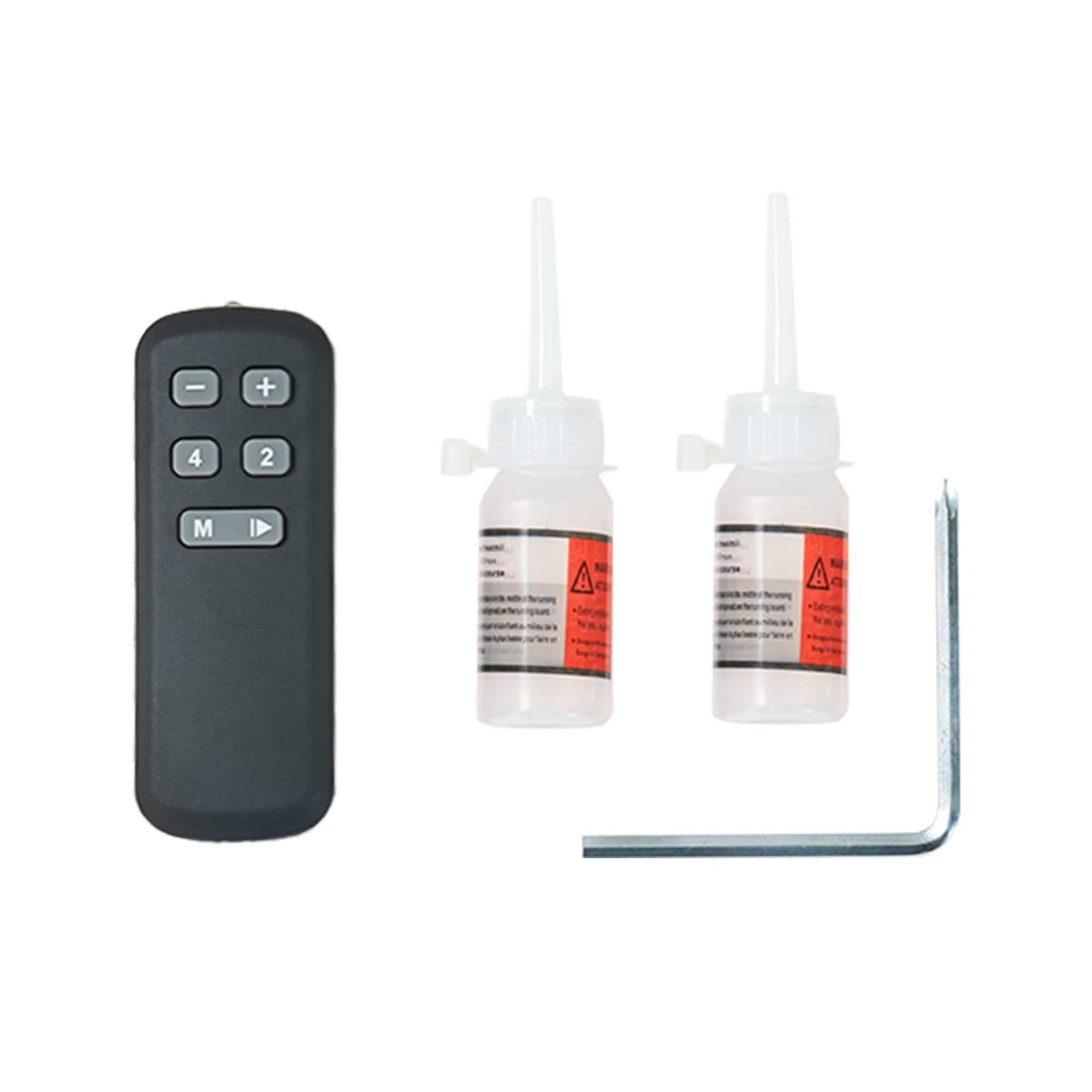Black remote control with two white bottles and a metal tool on a white background