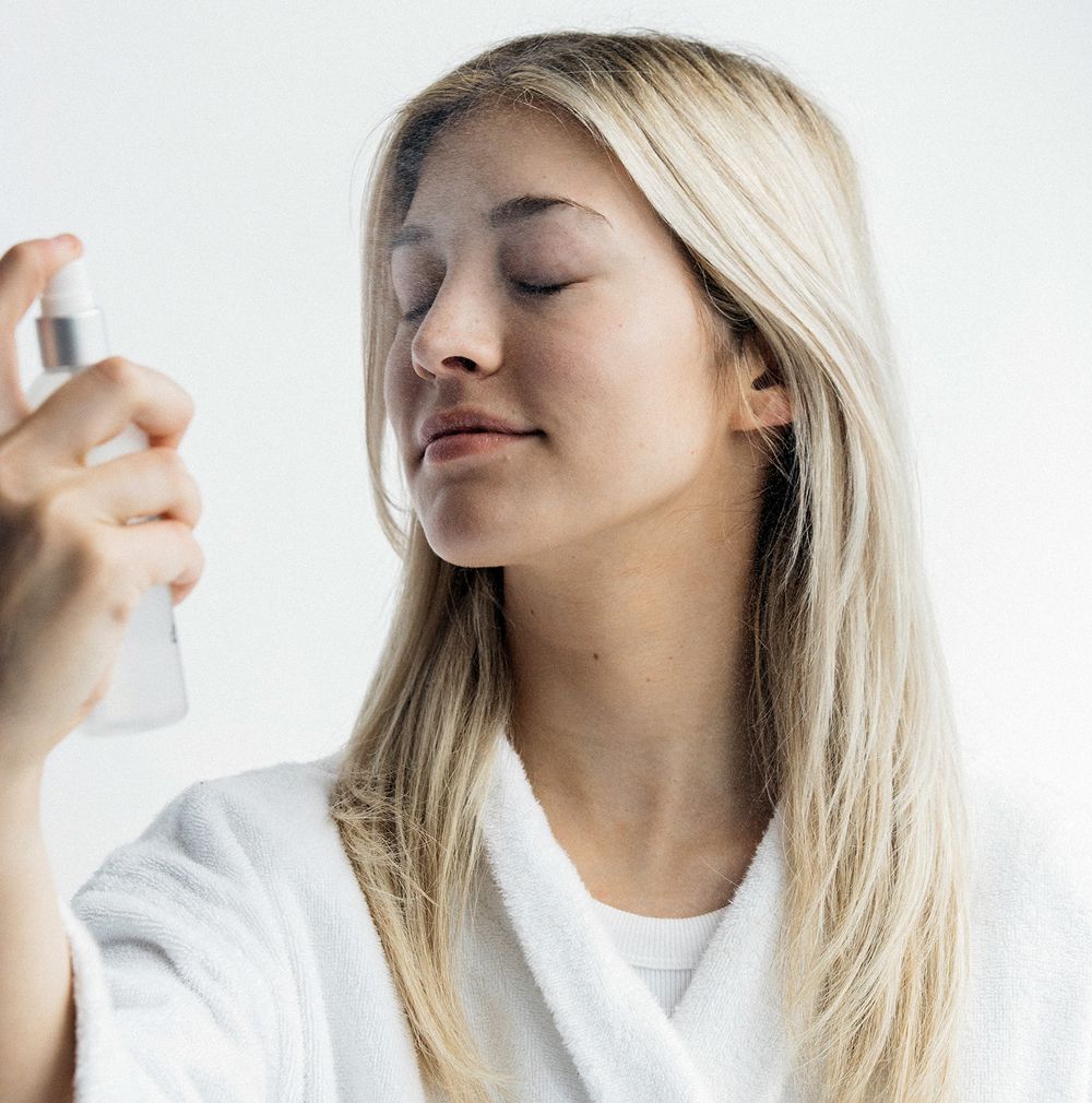 Woman applying a product to her face.