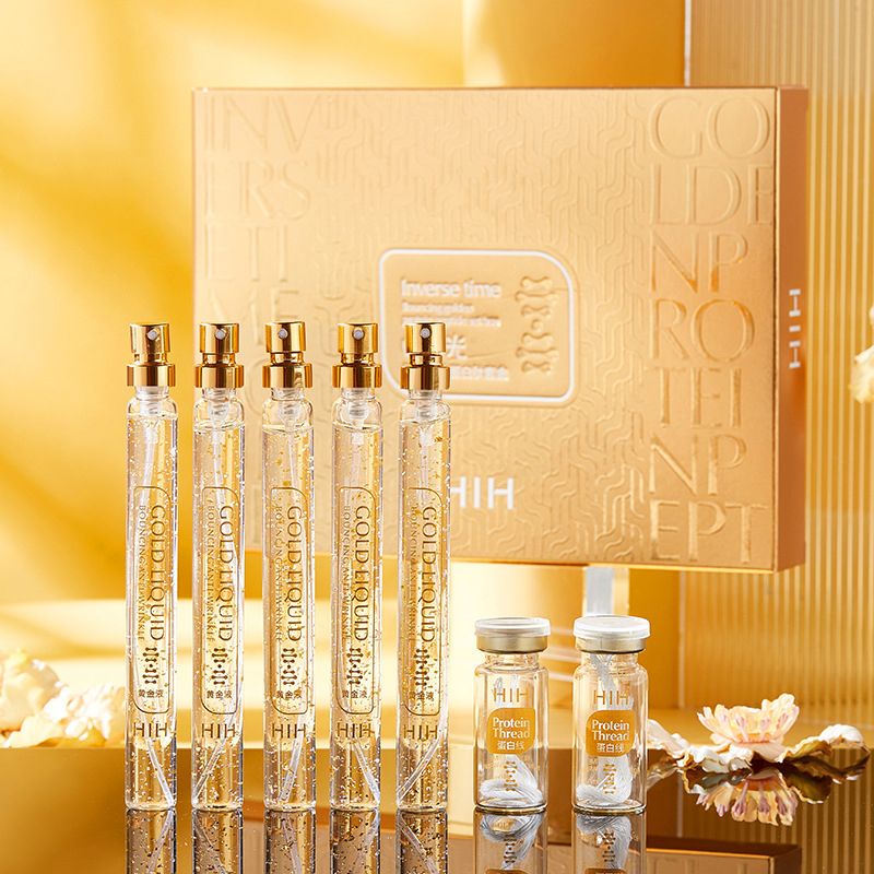 Set of gold and silver skincare products with a decorative box.