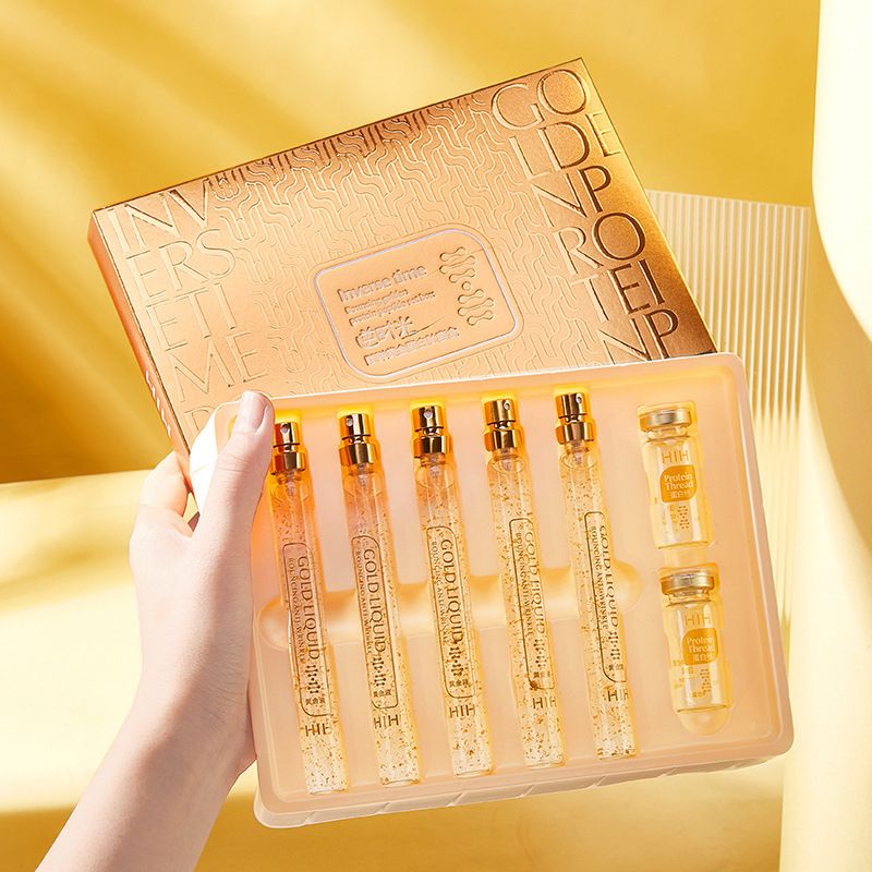 Set of gold skincare bottles.
