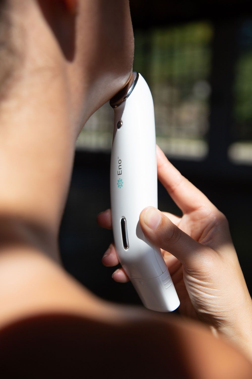 Person holding a white electronic device with 'EUNI' branding.