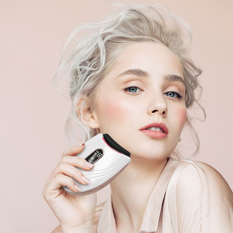 Woman holding a white electronic device against her face .