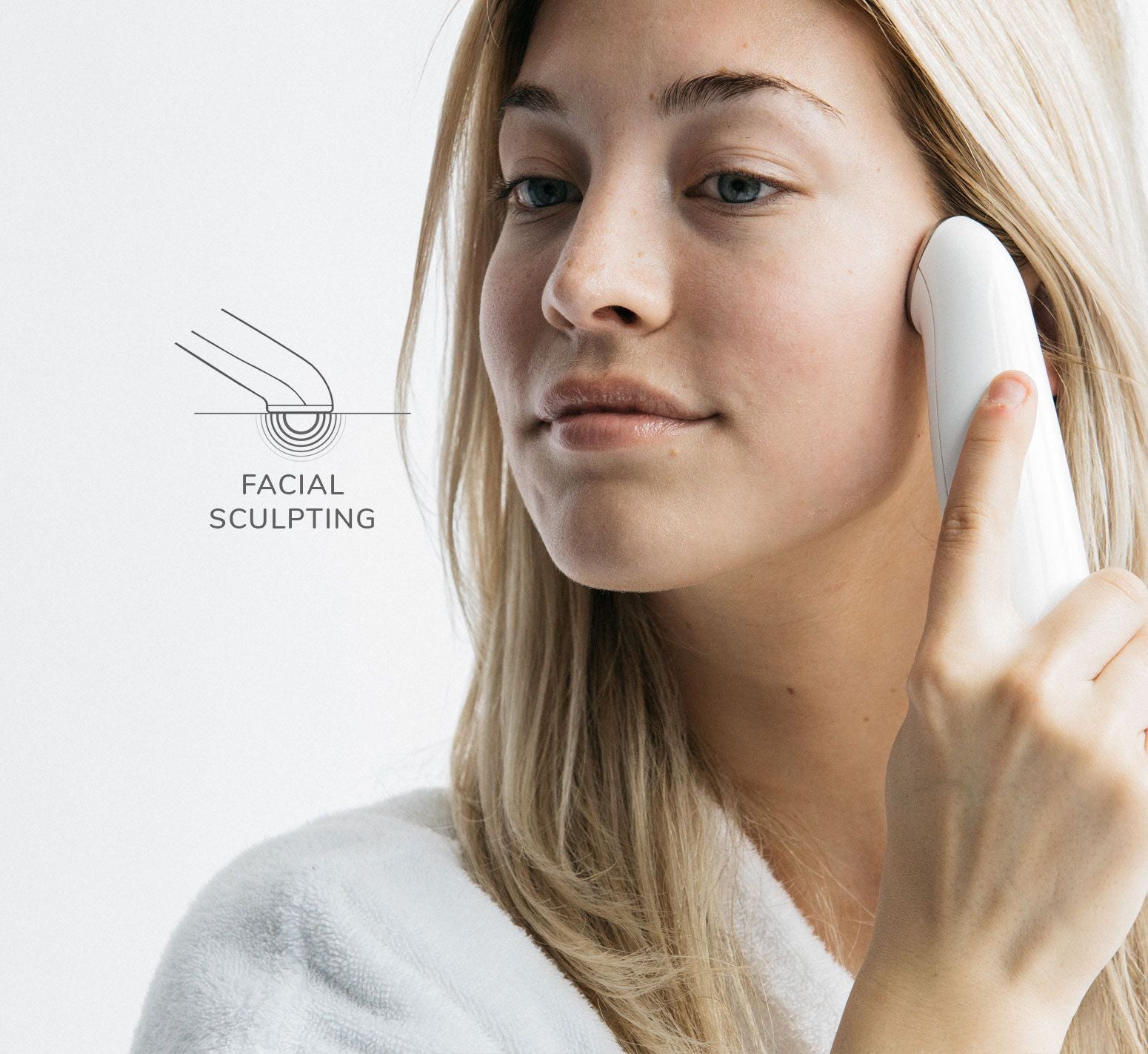 Woman using a facial sculpting device.